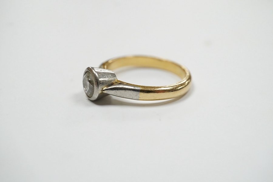 A yellow metal and collet set solitaire diamond set ring, size J/K, gross weight 4.2 grams. Condition - fair